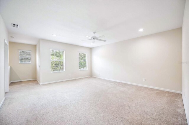 unfurnished room with ceiling fan and light colored carpet