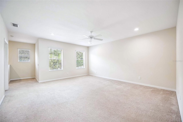 unfurnished room featuring recessed lighting, visible vents, light carpet, ceiling fan, and baseboards