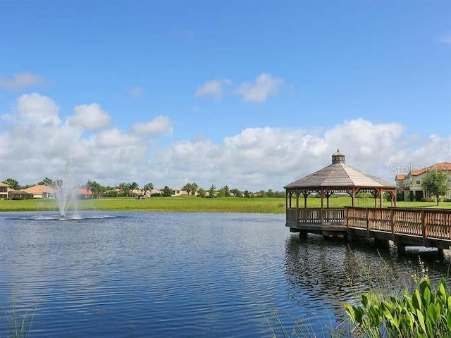 view of dock featuring a gazebo and a water view