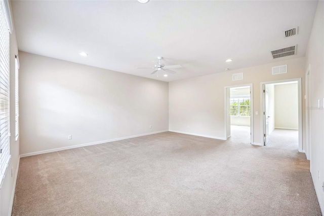 unfurnished room with recessed lighting, visible vents, and light carpet