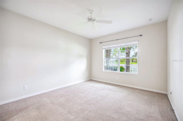 unfurnished room with light carpet and ceiling fan