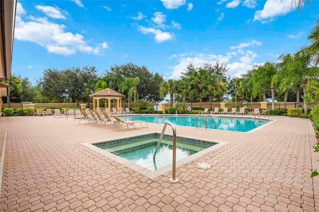 view of swimming pool with a gazebo, a patio, and a hot tub