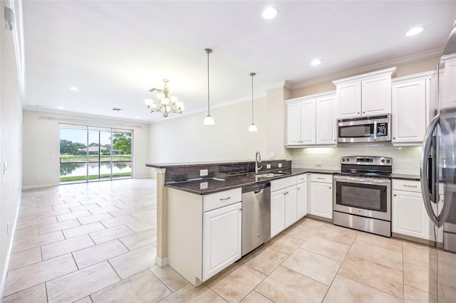 kitchen with kitchen peninsula, stainless steel appliances, white cabinetry, and hanging light fixtures