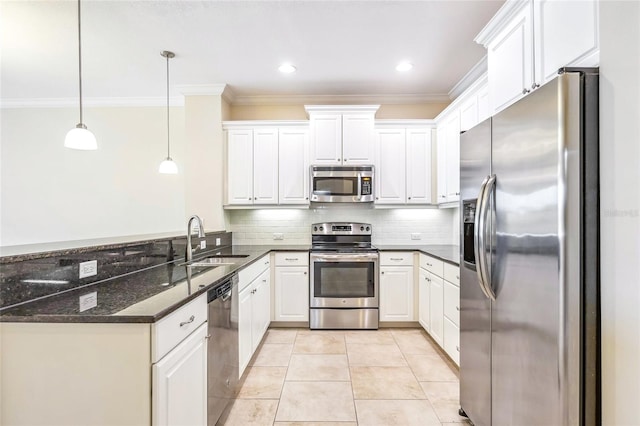 kitchen with pendant lighting, sink, appliances with stainless steel finishes, light tile patterned flooring, and white cabinetry