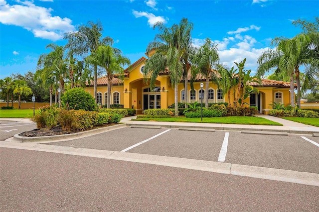 view of front of property featuring a tiled roof and stucco siding