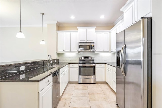 kitchen with light tile patterned floors, a sink, appliances with stainless steel finishes, backsplash, and crown molding