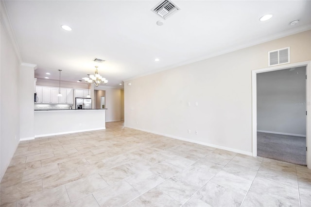 unfurnished living room featuring an inviting chandelier, baseboards, visible vents, and ornamental molding