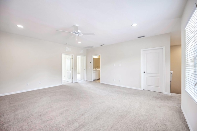 empty room featuring baseboards, light carpet, visible vents, and recessed lighting