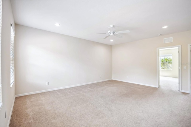 carpeted spare room with a ceiling fan, recessed lighting, visible vents, and baseboards