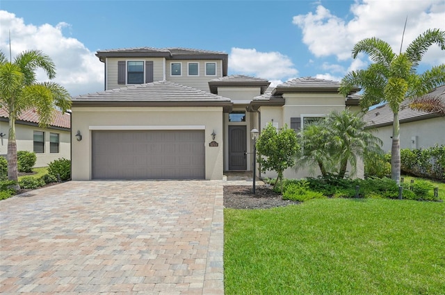 view of front of house featuring a front yard and a garage