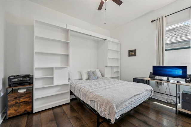 bedroom with dark hardwood / wood-style flooring and ceiling fan