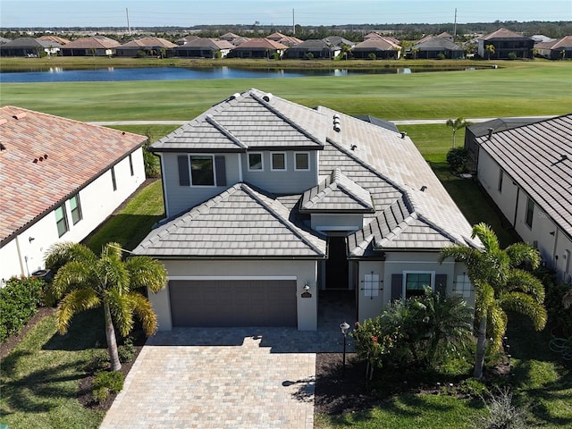 view of front of property with a water view and a garage