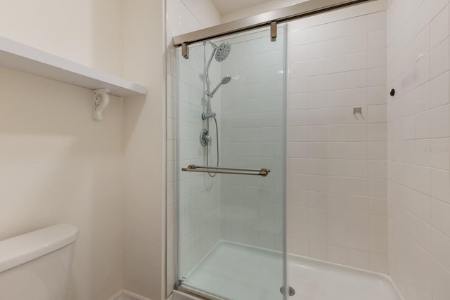 bathroom featuring an enclosed shower and toilet