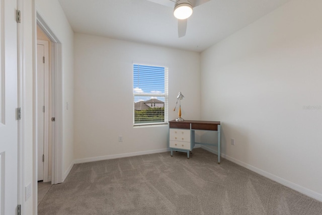 unfurnished office with ceiling fan and light carpet