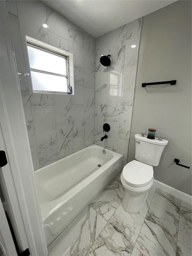 bathroom with toilet and tiled shower / bath combo