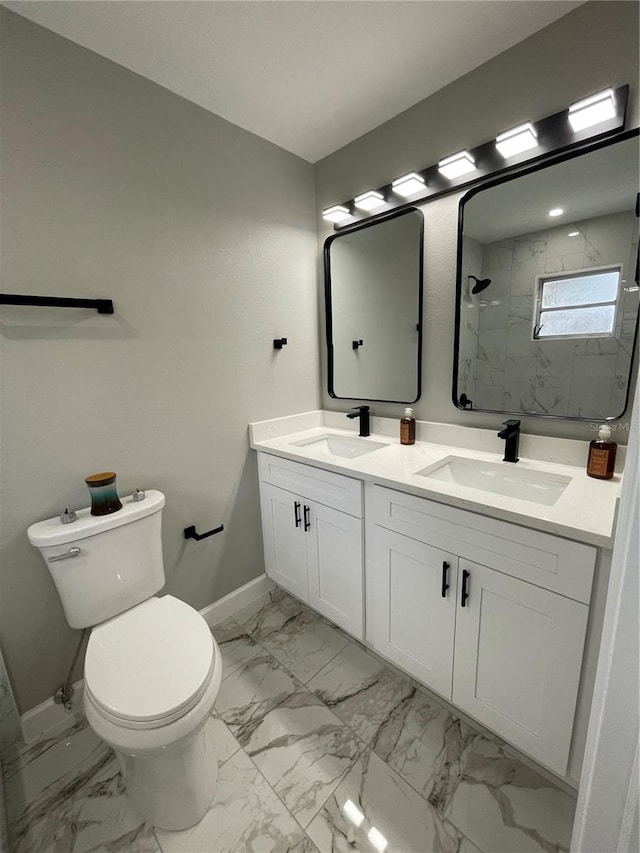 bathroom featuring vanity, a tile shower, and toilet