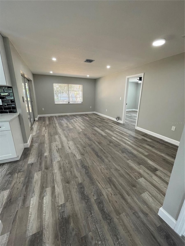 unfurnished living room featuring dark hardwood / wood-style flooring