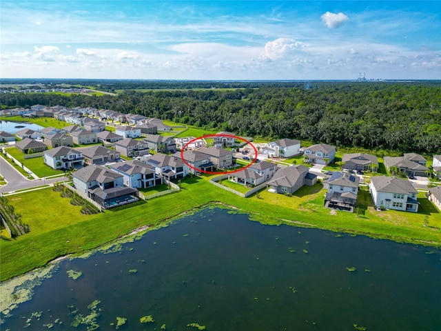 bird's eye view featuring a view of trees, a residential view, and a water view