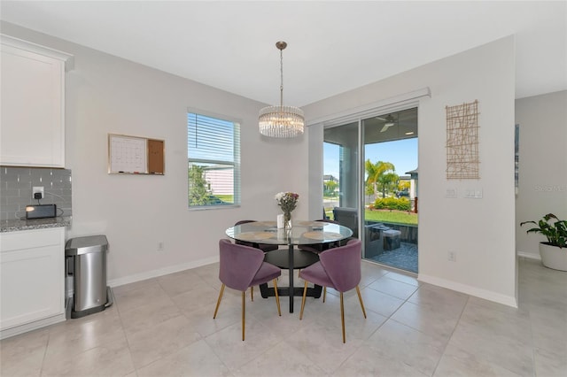 dining area with a chandelier and light tile patterned floors