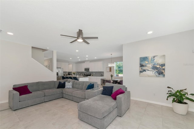 living room featuring ceiling fan and light tile patterned flooring