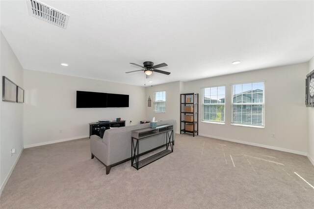 living room featuring ceiling fan and light colored carpet