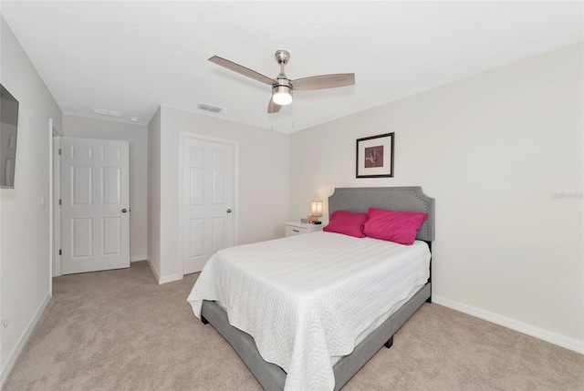 bedroom with ceiling fan, visible vents, baseboards, and light colored carpet