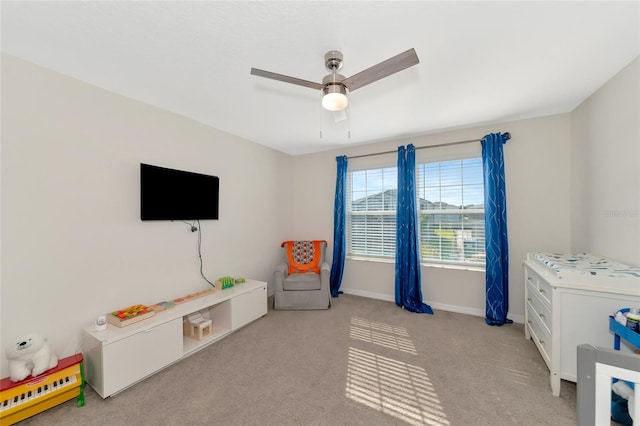 rec room with ceiling fan and light colored carpet