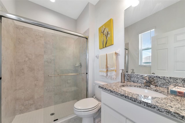 bathroom with toilet, an enclosed shower, and vanity