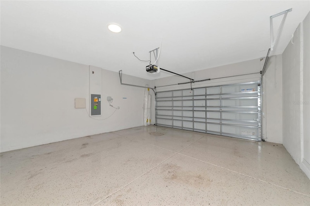 garage with electric panel and a garage door opener