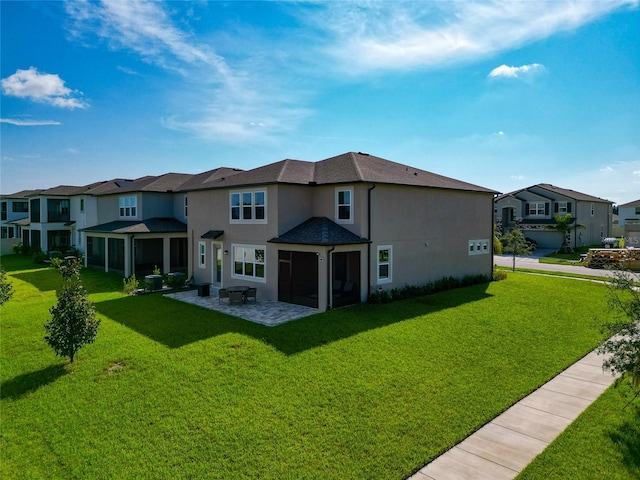 back of property featuring stucco siding, a residential view, a yard, and a patio