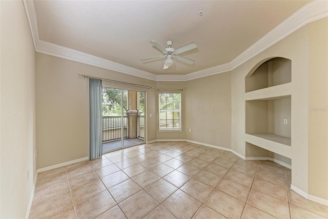 spare room featuring built in shelves, crown molding, ceiling fan, and light tile patterned floors