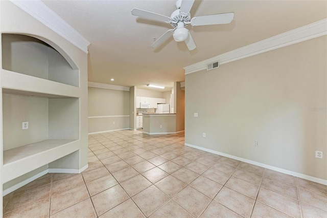 tiled spare room featuring ceiling fan and ornamental molding