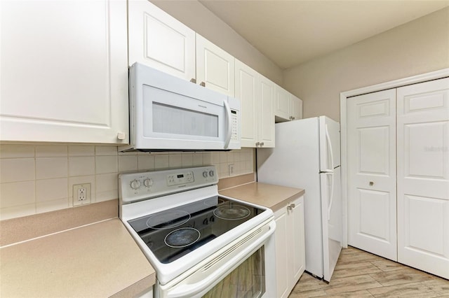 kitchen featuring light wood-type flooring, white appliances, white cabinetry, and decorative backsplash