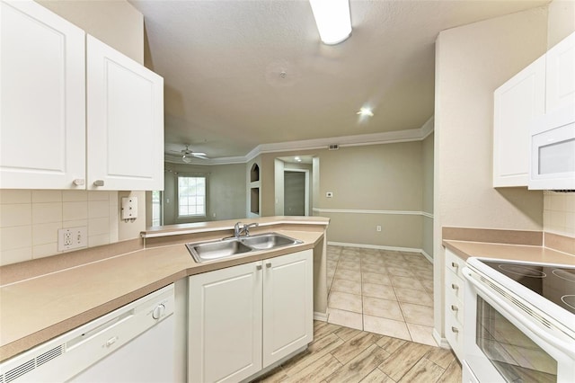 kitchen featuring white appliances, light hardwood / wood-style flooring, backsplash, sink, and ceiling fan