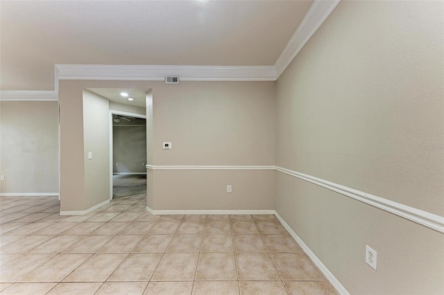 tiled spare room featuring crown molding