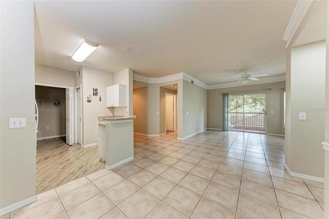 interior space with crown molding, white cabinetry, ceiling fan, and light hardwood / wood-style floors