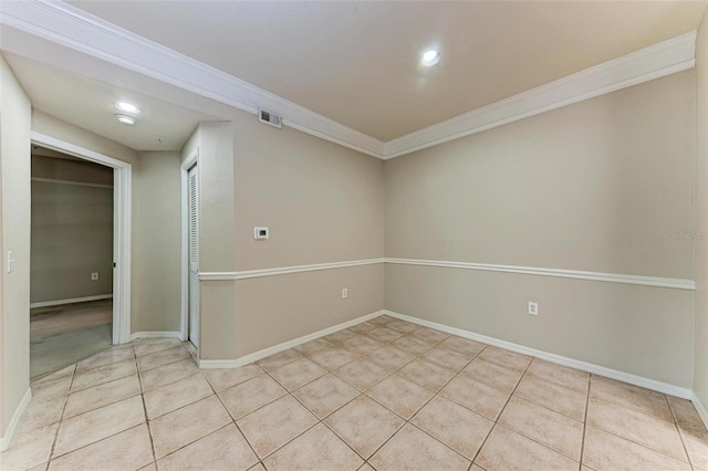 unfurnished room featuring crown molding and light tile patterned floors