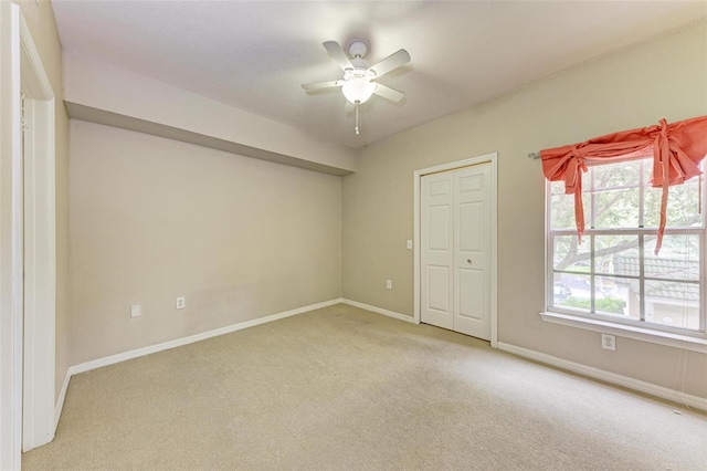 unfurnished bedroom with ceiling fan, a closet, and carpet floors