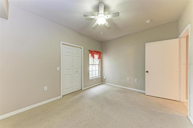 unfurnished bedroom with light carpet and ceiling fan