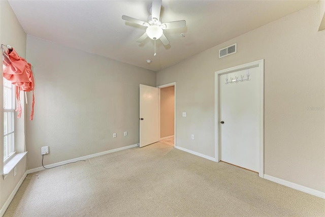 empty room featuring light carpet and ceiling fan