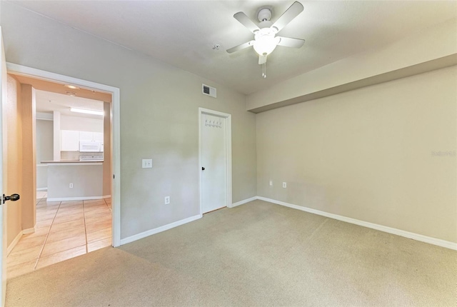 unfurnished bedroom featuring light carpet and ceiling fan