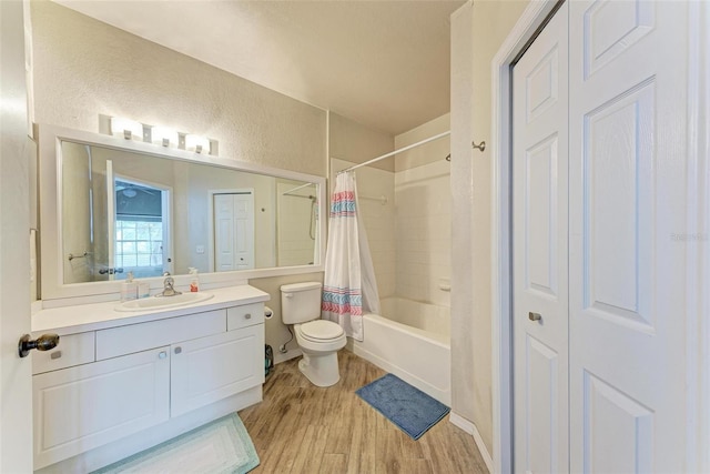 full bathroom with vanity, toilet, hardwood / wood-style flooring, and shower / bath combination with curtain