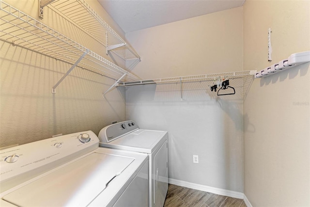 washroom with independent washer and dryer and hardwood / wood-style flooring