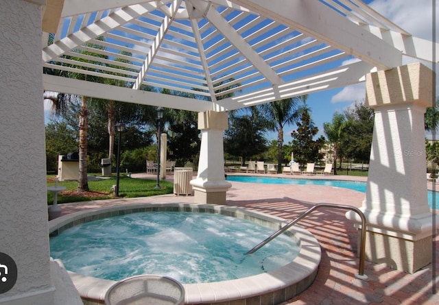 view of swimming pool with a community hot tub and a pergola