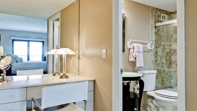 bathroom featuring toilet, a stall shower, visible vents, and connected bathroom