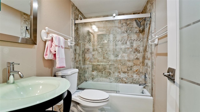 full bath with enclosed tub / shower combo, vanity, and toilet