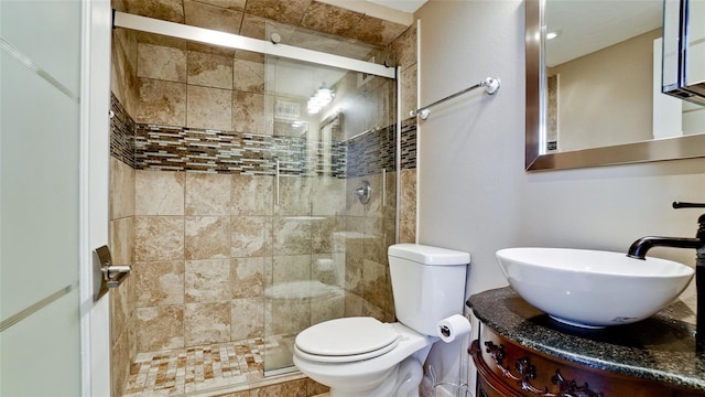 bathroom with toilet, walk in shower, and vanity