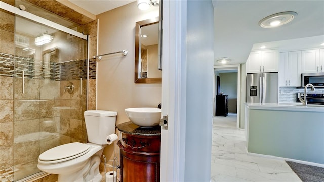 bathroom with tile patterned flooring, vanity, walk in shower, and toilet