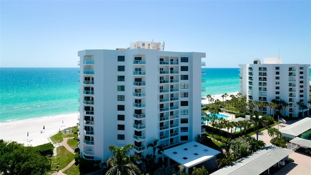 view of property with a beach view and a water view