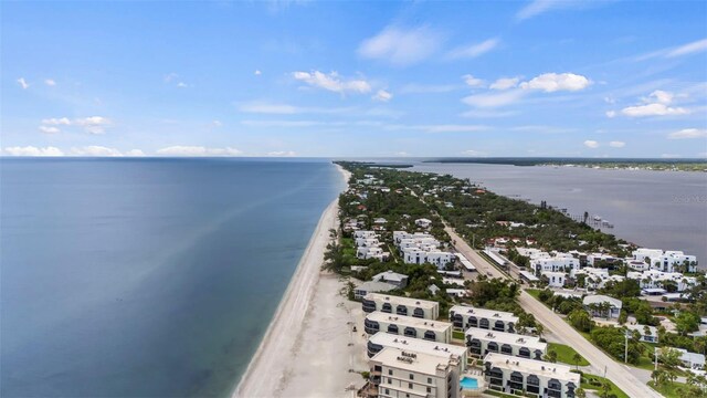 birds eye view of property with a water view and a view of the beach